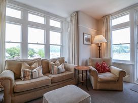 A living room with a sofa and armchair at 2 York House in Dartmouth