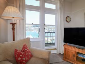 A living room with a window view and a sofa at 2 York House in Dartmouth