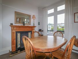 A dining room with a table and chairs at 2 York House in Dartmouth