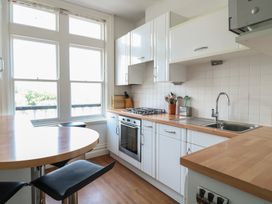 A kitchen with cabinets and a gas stove at 2 York House in Dartmouth
