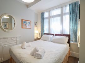 A bedroom with a bed and bedside lamp at 2 York House in Dartmouth