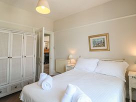 A bedroom with a bed and wardrobe at 2 York House in Dartmouth