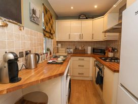 A kitchen with wooden countertops white cabinets and appliances at 202 Salisbury Terrace in York