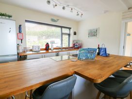 A kitchen with a fridge and kitchen appliances at Daisy Cottage Benllech
