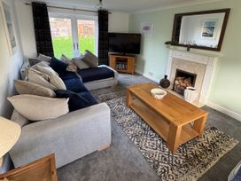 A living room with a sofa and television at Fistral Bay Cottage in Newquay