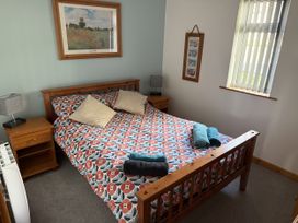 A bedroom with a bed and bedside table at Hembry Meadows near Gunnislake