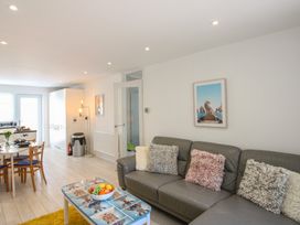 A living room with a sofa and dining table at Little Starboard in Kingsbridge