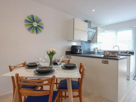 A kitchen with a dining area and a table set at Little Starboard in Kingsbridge