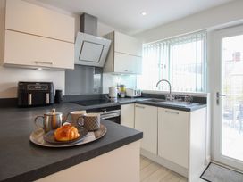 A kitchen with cabinets and a sink at Little Starboard in Kingsbridge