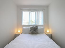A bedroom with a bed and window at Little Starboard in Kingsbridge