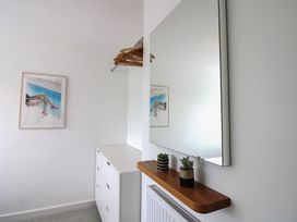 A bedroom with a mirror and plant pots at Little Starboard in Kingsbridge