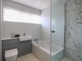 A bathroom with a bathtub and sink at Little Starboard in Kingsbridge