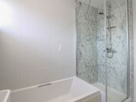 A bathroom with a bathtub and shower at Little Starboard in Kingsbridge