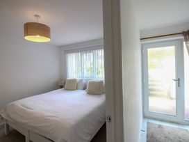 A bedroom with a bed and a door leading outside at Little Starboard in Kingsbridge