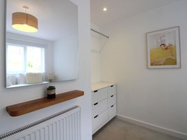 A bedroom with a mirror and drawer unit at Little Starboard in Kingsbridge