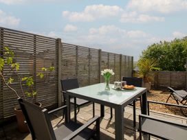 An outdoor dining area with a table and chairs at Little Starboard in Kingsbridge