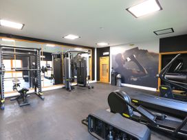 A gym with exercise equipment and a wall mural at Honeybee Cottage in Penruddock