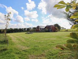 A glamping pod on a grassy field at Embden Pod at Banwy Glamping Llanfair Caereinion