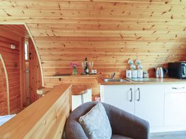 A kitchen with wooden walls and furniture at Embden Pod at Banwy Glamping Llanfair Caereinion