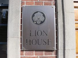 A plaque with 'LION HOUSE' and a lion head displayed at Lion House in Moretonhampstead