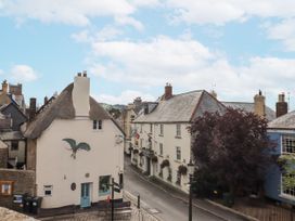 A view of houses and a tree on a street at Lion House in Moretonhampstead