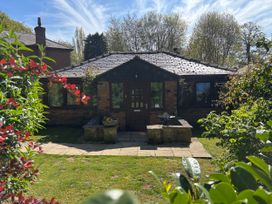 A house with a garden and pathway at Claire Cottage in Gateforth near Hambleton, North Yorkshire