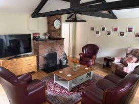 A living room with a television and a fireplace at Claire Cottage, Gateforth near Hambleton, North Yorkshire