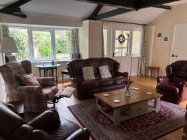 A living room with sofas and a table at Claire Cottage near Hambleton, North Yorkshire