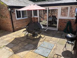 An outdoor area with a table and chairs at Claire Cottage Gateforth near Hambleton, North Yorkshire