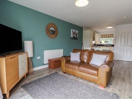 A living room with a sofa and television at Buck Place The Bay - Filey
