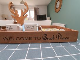 A wooden tray with coffee cups and decorative items at Buck Place The Bay - Filey