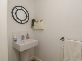 A bathroom with a sink and mirror at Buck Place The Bay - Filey