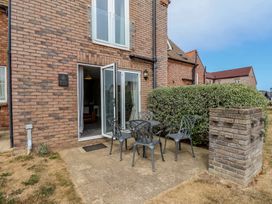 An outdoor area with a table and chairs at Buck Place The Bay - Filey