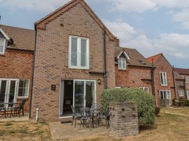 An outdoor area with seating and a brick building at Buck Place The Bay - Filey