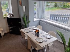A dining room with a table and chairs at Bryn in Bethesda