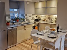 A kitchen with appliances and a dining table at Annest in Bethesda