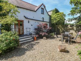 A garden with steps, table and chairs at Stable Cottage, Narberth