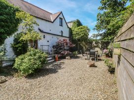 A garden with gravel, plants, and outdoor furniture at Stable Cottage, Narberth