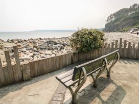 A bench overlooking the sea and rocks at Stable Cottage, Narberth near Templeton