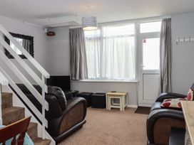 A living room with a sofa and window at Turtle Chalet in Dawlish Warren