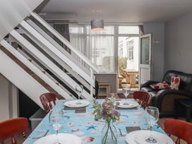 A dining area with a table set for a meal at Turtle Chalet in Dawlish Warren