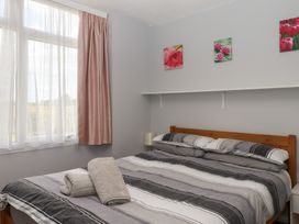 A bedroom with a bed and window at Turtle Chalet in Dawlish Warren