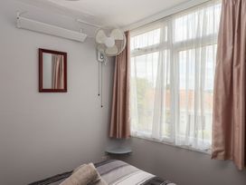 A bedroom with a bed and window at Turtle Chalet in Dawlish Warren