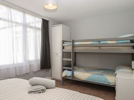 A bedroom with a bunk bed and a double bed at Turtle Chalet in Dawlish Warren