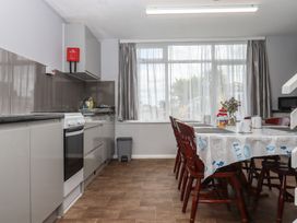 A kitchen with a table and chairs at Dolphin Chalet, Dawlish Warren