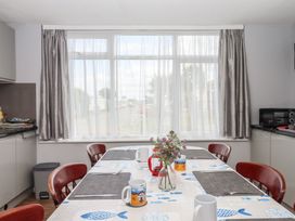 A dining room with a table and chairs at Dolphin Chalet in Dawlish Warren