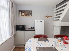 A kitchen with a table and chairs at Dolphin Chalet in Dawlish Warren
