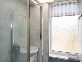 A bathroom with a shower and sink at Dolphin Chalet in Dawlish Warren