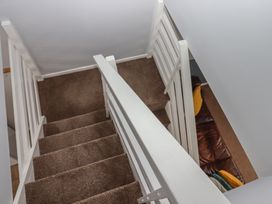 A stairwell with carpeted stairs and handrail at Dolphin Chalet Dawlish Warren