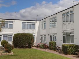 An outdoor area with buildings and benches at Dolphin Chalet in Dawlish Warren